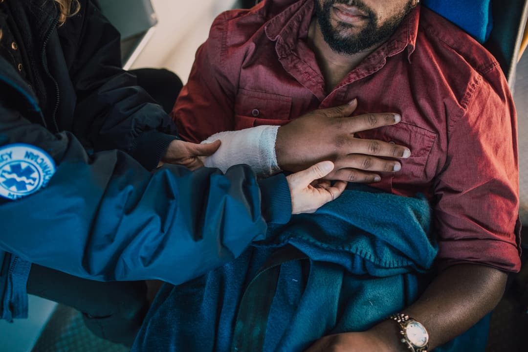 Nurse applying wound dressing to a patient at home