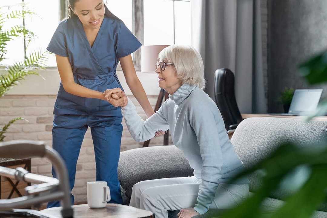 Nurse applying wound dressing to a patient at home