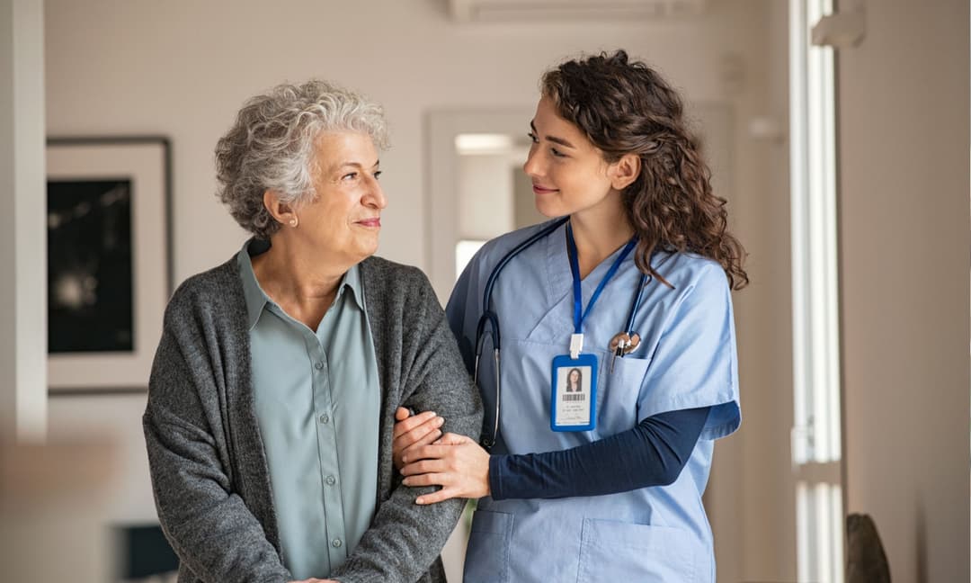 Clinician providing wound care to a patient at home